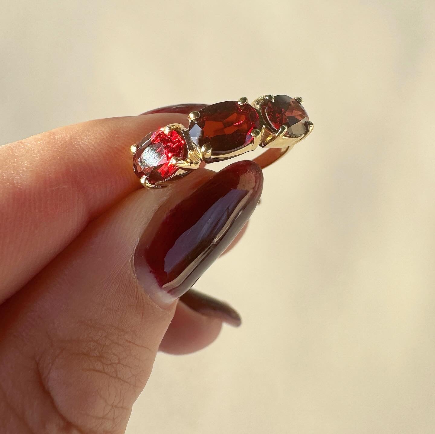 14k yellow gold oval garnet trilogy ring