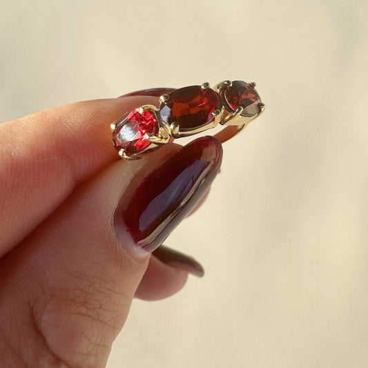 14k yellow gold oval garnet trilogy ring